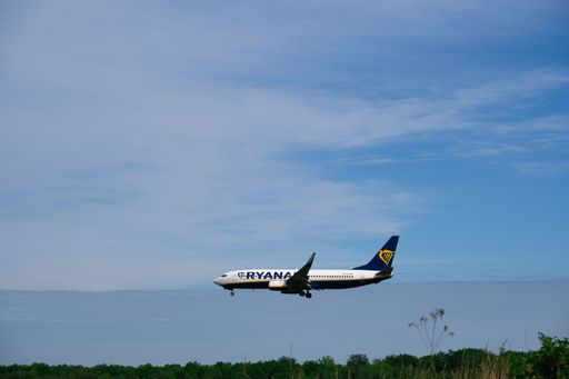 airplane on approach for landing, rear view just before landing, blue sky