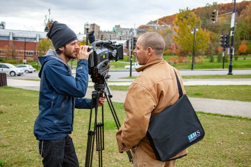 Montreal, Quebec / Canada - October 16 2010: Cameraman Using Panasonic Shoulder Mount Camera on a Tripod next to a Short-Haired Man
