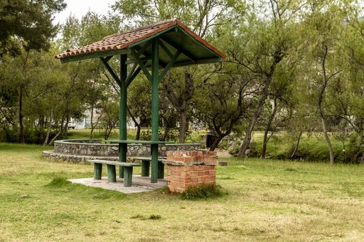 A closeup shot of a park with an open air seating area for picnics
