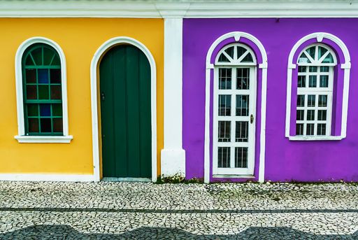 A beautiful shot of a building in yellow and purple colors on a sunny day