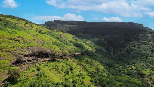 A mesmerizing view of mountains area covered with natural green under cloudy sky