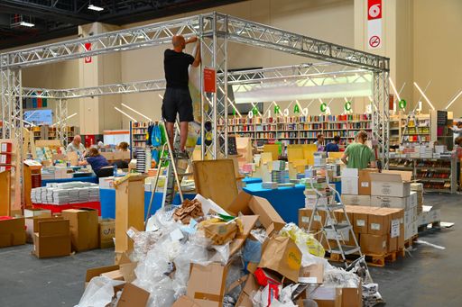 A worker setting up a booth the day before the opening of the international book fair in Turin, Italy