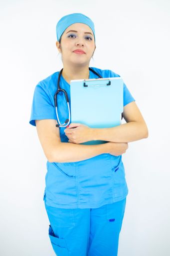 A portrait of a healthcare provider in uniform and holding a clipboard on a white background