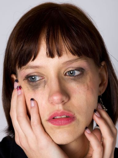 A sad woman holding his head while crying