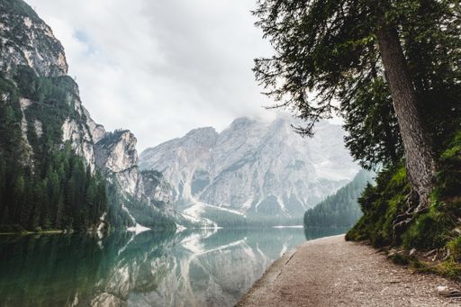A breathtaking landscape shot of a river surrounded by mountains and trees in Banff National Park, Canada. Perfect for a travel piece.