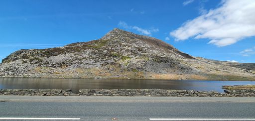 The blue sky over the calm lake on a sunny day in spring captured from the road