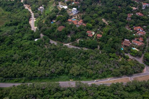 An aerial view of an urban area in a small town surrounded by trees and greenery
