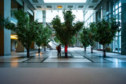 Montreal, Quebec / Canada - March 31 2013: Couple Inside A Vast Buisness Centre Interior with Several Green Real Trees