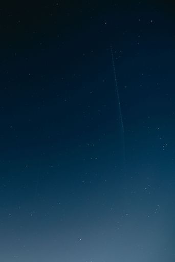 A vertical shot of stars in a blue sky
