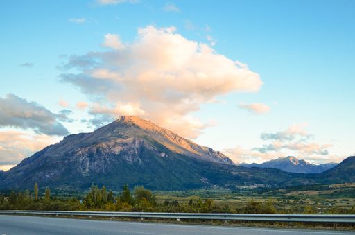 The beautiful high mountains covered in greens and gleaming under the cloudy sky