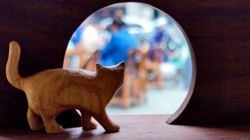 A closeup shot of a small wooden cat figurine