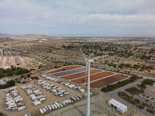 An aerial view of a large windmill at Lake Palmdale near a water treatment