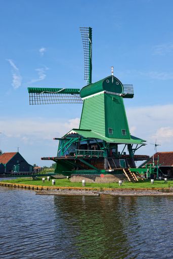 A vertical shot of the green windmill in Zaanse Schans, Zaandam, the Netherlands