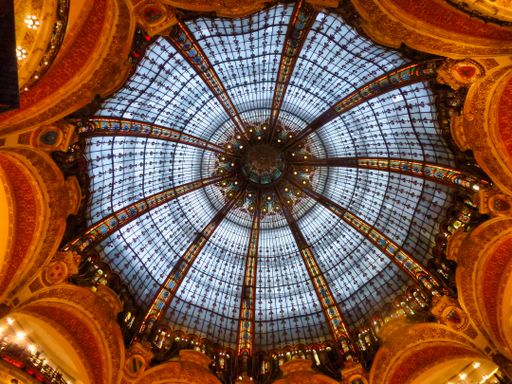 A low angle shot of the glass beautiful dome ceiling of Galeries Lafayette in Paris
