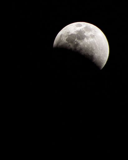 A beautiful shot of a fading moon isolated on a dark black night sky