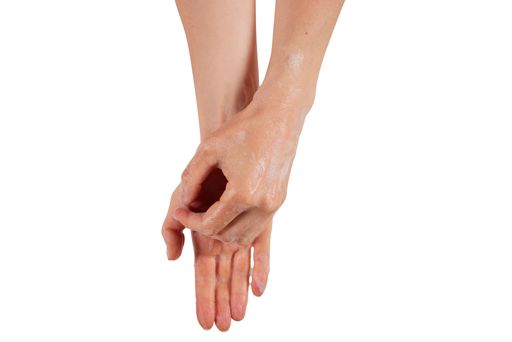 A woman removing soap from wet hands during hygienic routine against white background