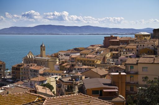 A beautiful shot of Porto Santo Stefano village with blue sky in the background