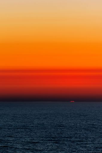 A vertical shot of a beautiful sunset at Cabo de San Vicente in the Algarve, southern Portugal