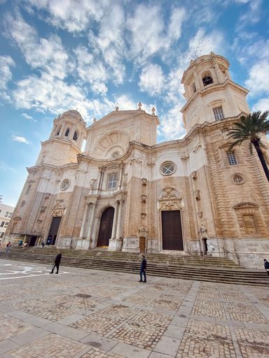 A vertical shot of the Cadiz Cathedral against the blue sky. Spain.