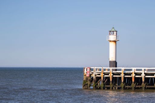 A beautiful shot of a lighthouse in Belgium on a blue sky background