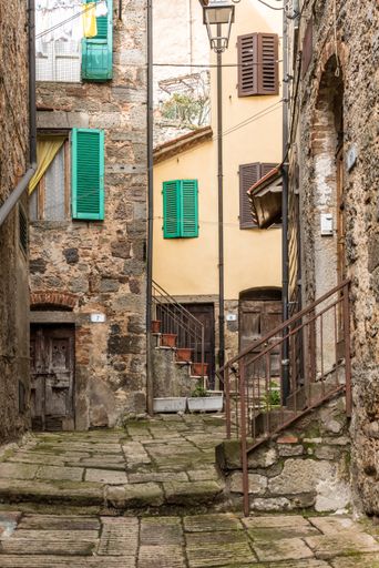 A vertical shot of an old neighborhood with ancient houses and old staircases