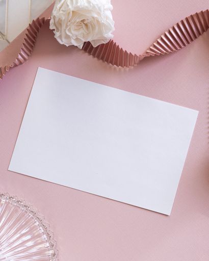 A paper on a pink surface with copy space