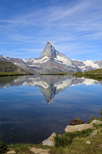 A vertical shot of mountain and its reflection in  Matterhorn Zermatt, Switzerland