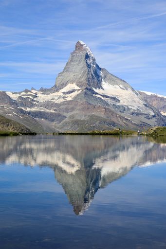A beautiful shot of a reflective lake surface on the Matterhorn mountain background in Switzerland