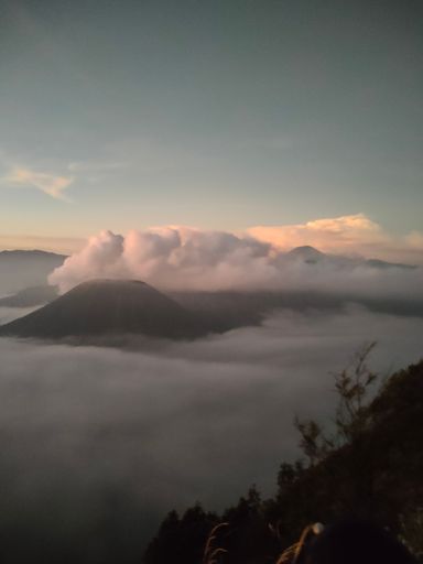 Mountain peak covered with clouds at sunset
