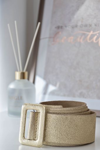 A vertical closeup shot of a golden jute basket over a background of incense sticks in a bottle