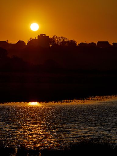 A vertical shot of a beautiful sunrise over the backwater at Walton-on-the-Naze, Essex