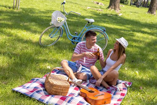 A beautiful lovely couple enjoying picnic day together in the park