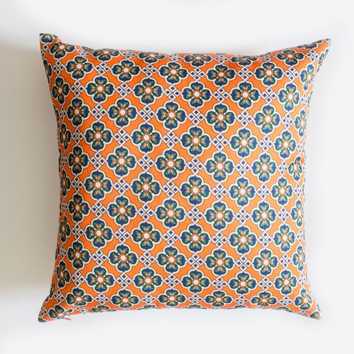 A decorative pillow with an abstract orange pattern isolated on a white background