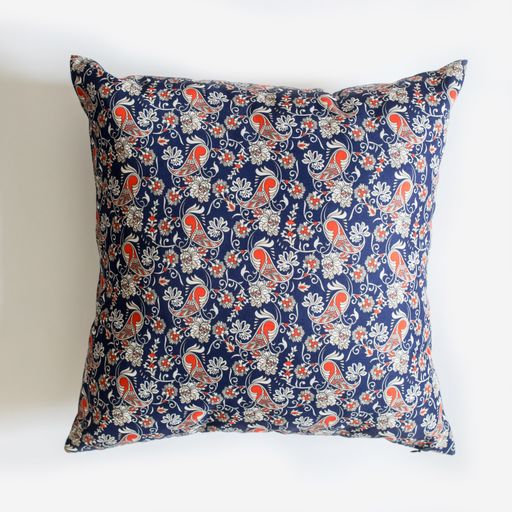 A decorative pillow with an abstract colorful pattern isolated on a white background