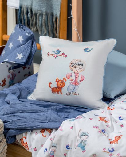 A vertical shot of kid bed linens with cute prints and a blue blanket