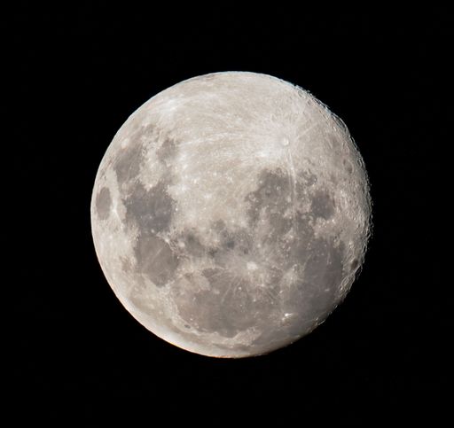 A beautiful round bright grey fool moon in a black sky