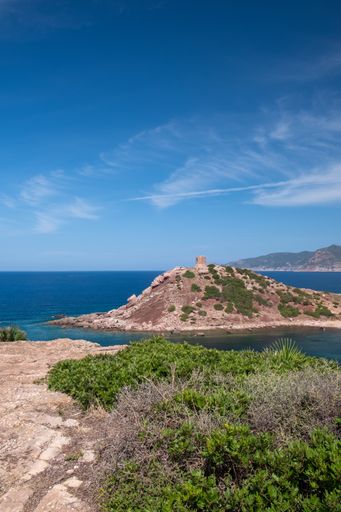A beautiful ocean surrounded by rocky hills during daytime