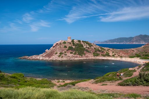 A beautiful ocean surrounded by rocky hills during daytime