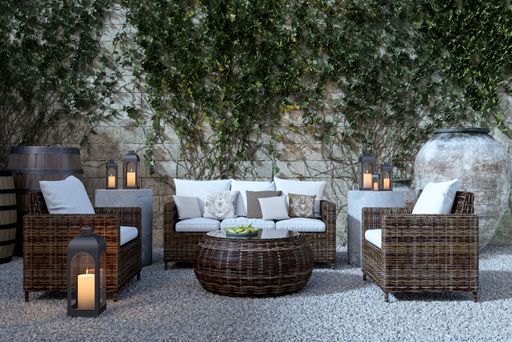 A beautiful shot of a restaurant hardware outdoor garden furniture, sofa and two chairs with circle table
