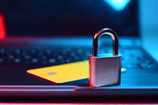 A closeup of a padlock with a credit card on a computer. Concept of e-commerce cybersecurity