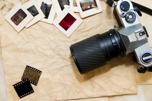 top view of an old camera with negatives and slides photography