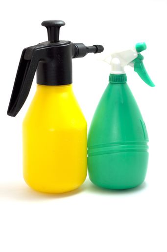 A vertical shot of yellow and green gardening tools on an isolated background