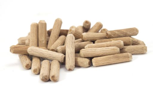 A closeup shot of wooden dowels isolated on a white background