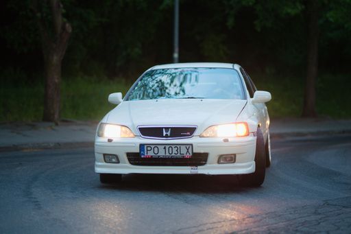 A white Honda Accord Type R taking a turn on a forest road