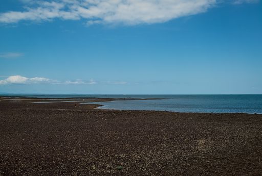 A horizontal shot of a beautiful low tide on a river estuary under the cloudy sky