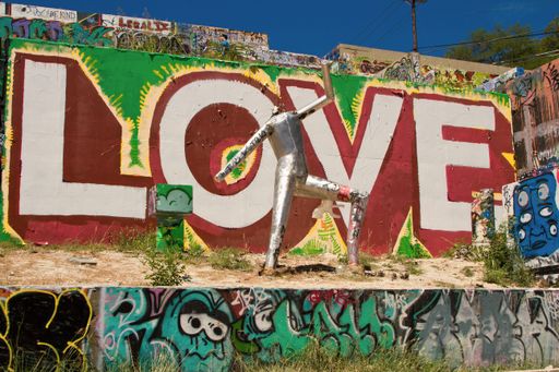A colorful graffiti with the word love on an old concrete garage wall in the street of Austin