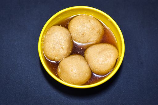 A high angle closeup shot of boiled potatoes in vinegar in a yellow bowl