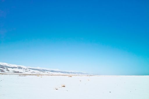 Clear, cloudless sky over a snowy field on a sunny day