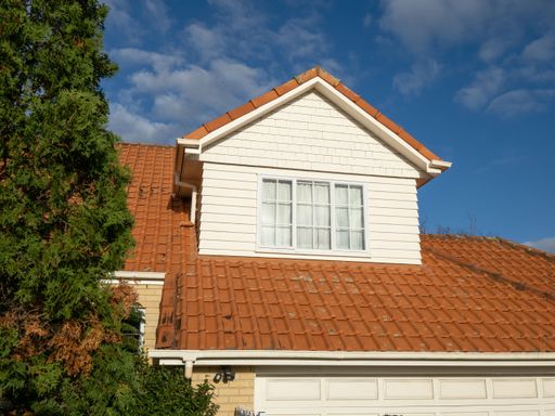 View of pitched roof dormer loft with window and concrete tiles