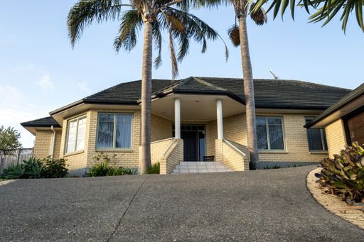 View of suburban house with palms